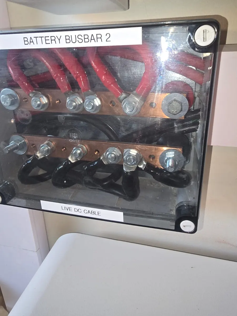 Copper battery busbar with live DC cables in a backup power installation