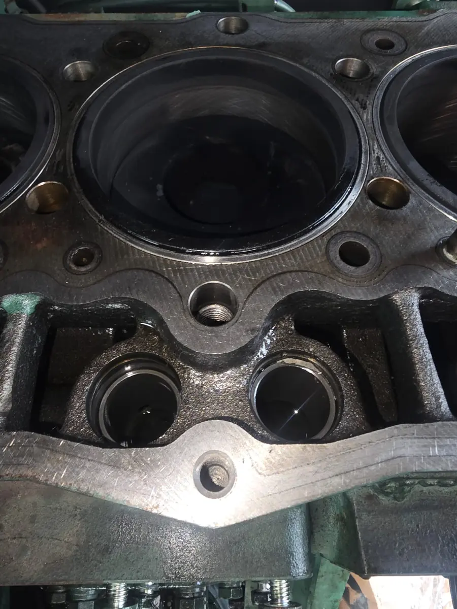 Cleaned cylinder bores in a diesel generator engine block ready for reassembly
