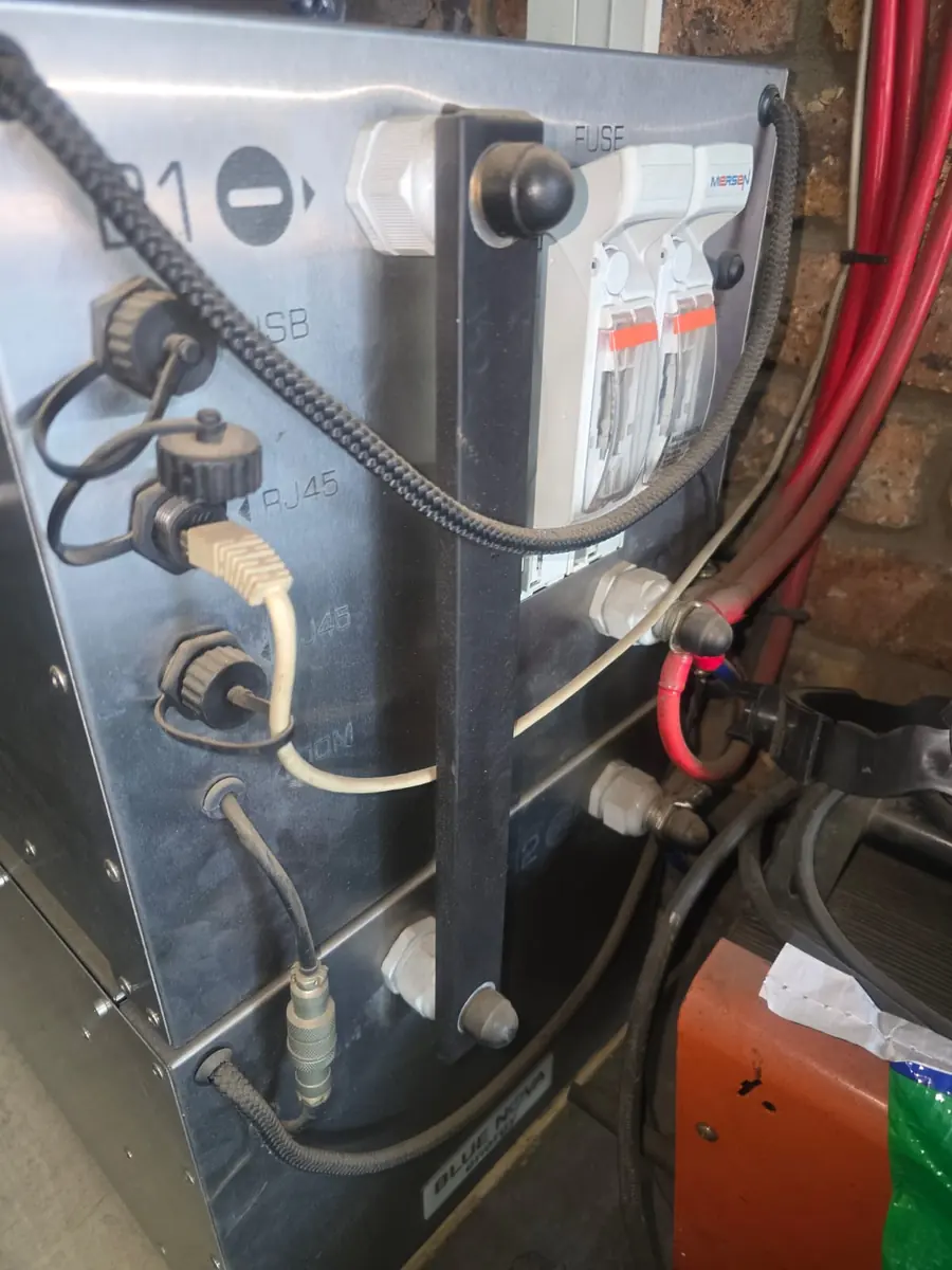 Communication and monitoring cables connected to a hybrid inverter and battery system