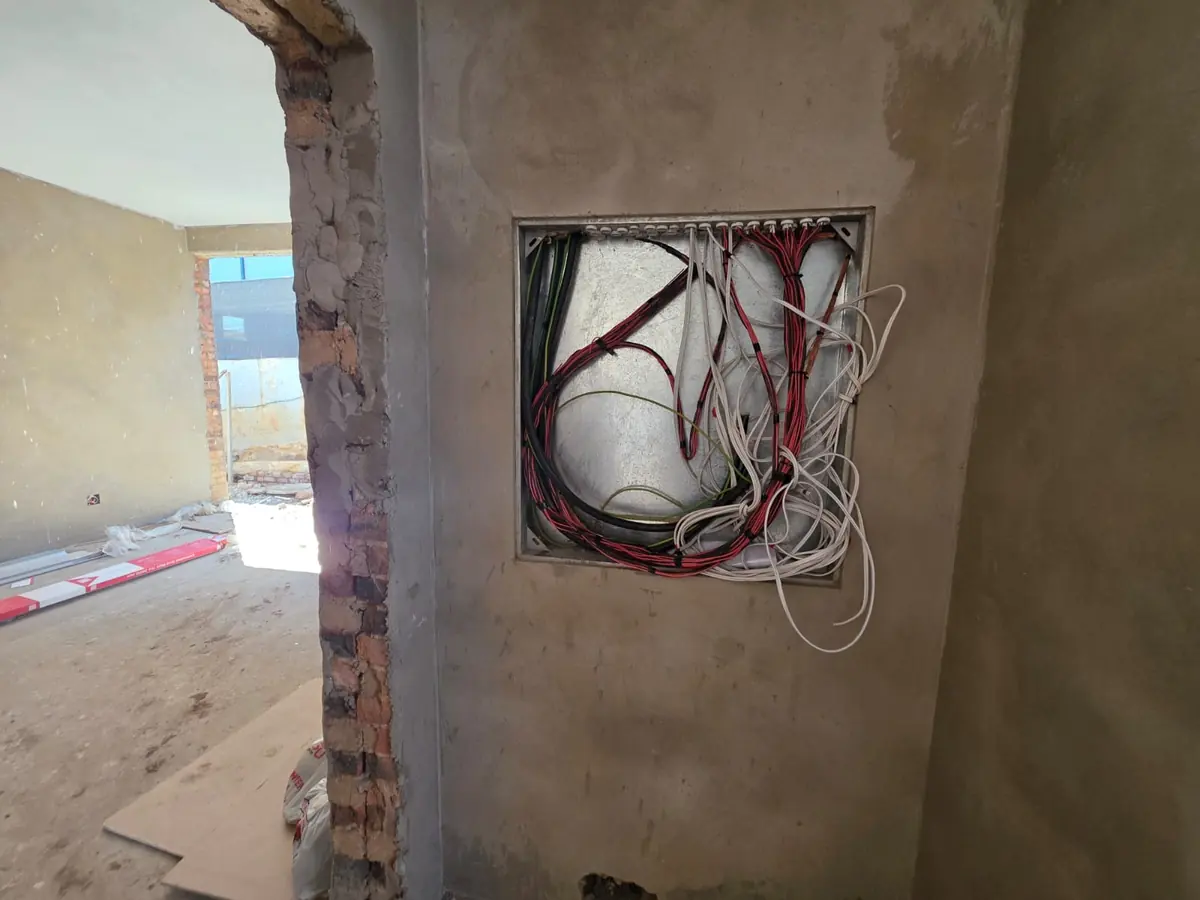 Distribution board recess with rough-in wiring in a new-build home before plastering