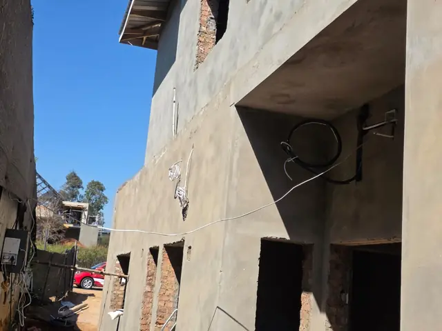 Double-storey house under construction with electrical conduit and cabling installed