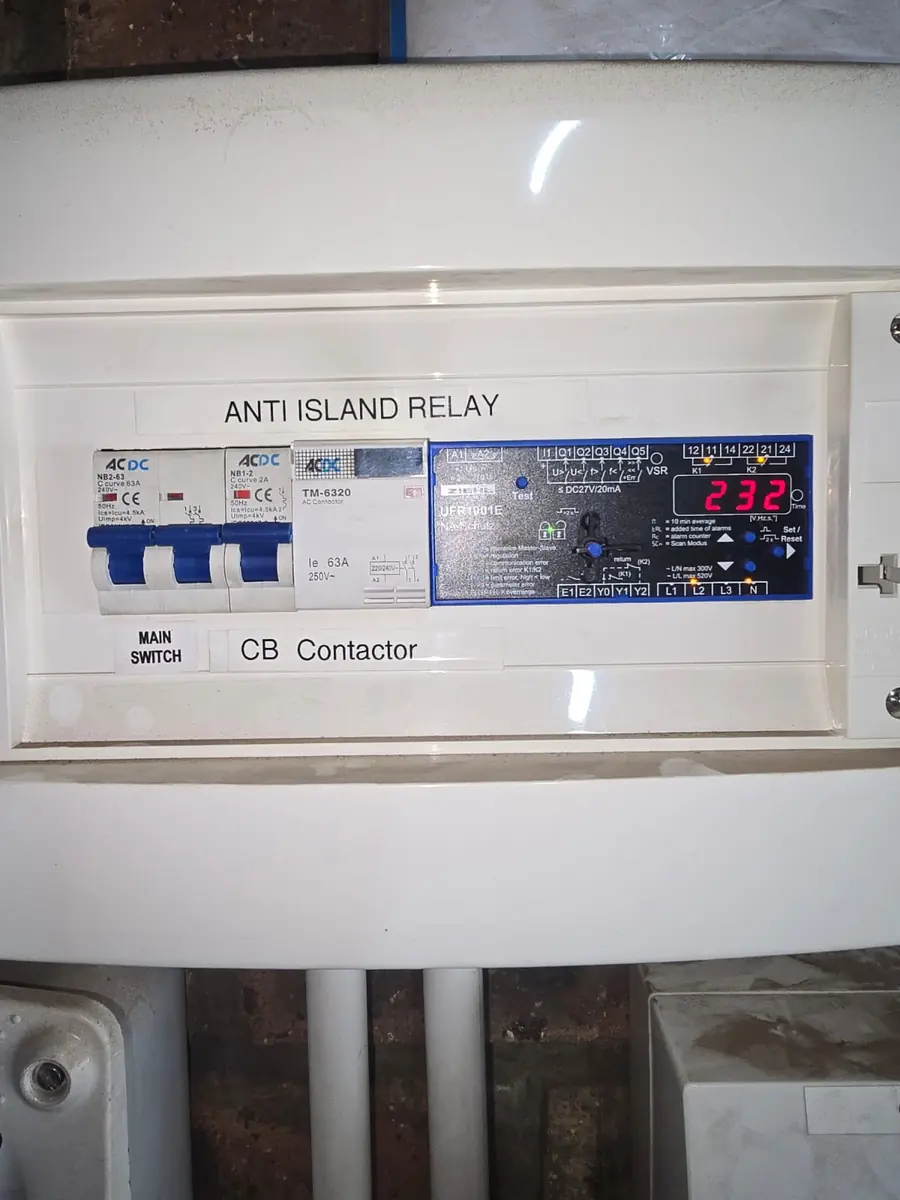 Anti-islanding relay and main switch on a grid-tied solar installation, showing 232 V grid voltage