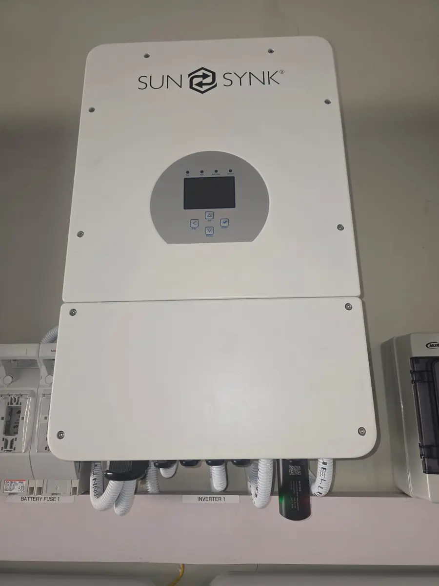Sunsynk hybrid inverter wall-mounted with battery fuse and DC isolator below