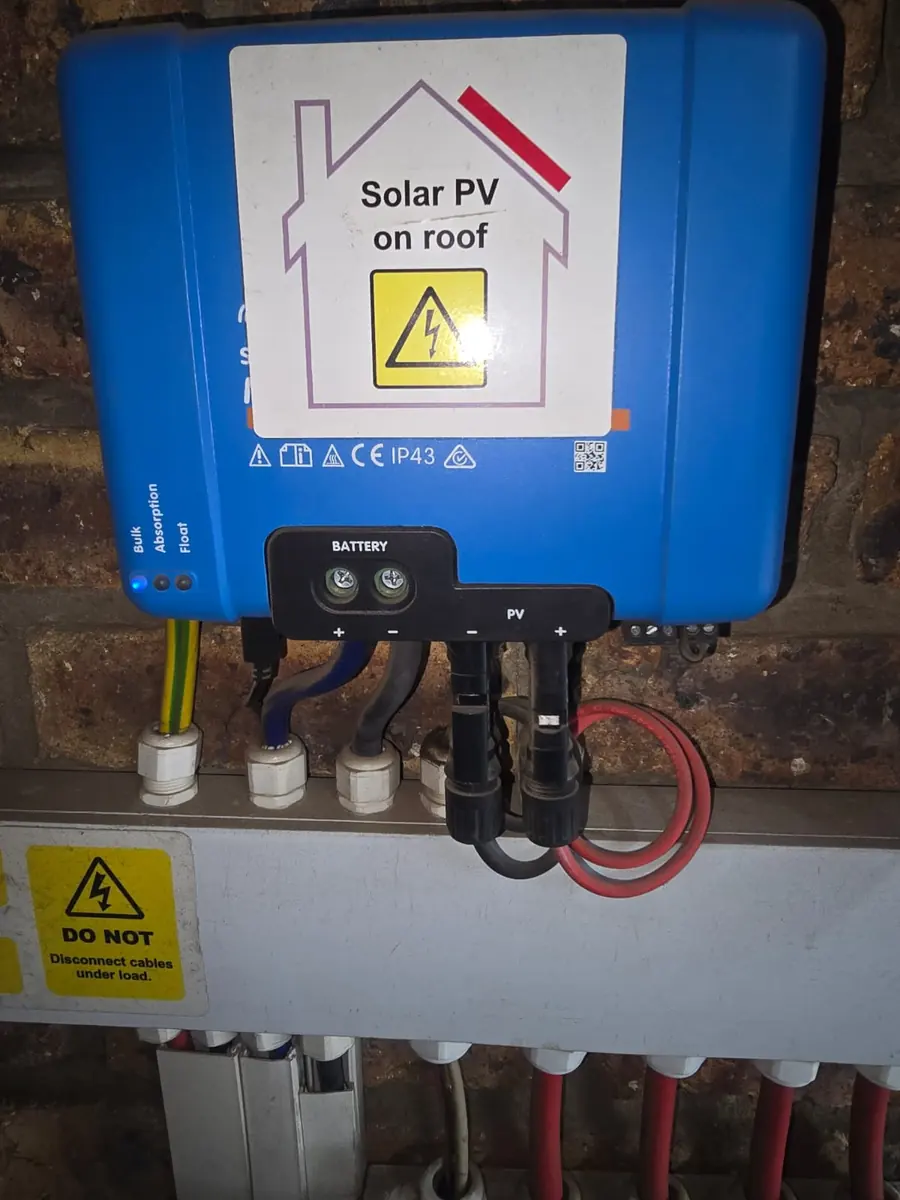 Victron SmartSolar MPPT charge controller with a 'Solar PV on roof' warning label